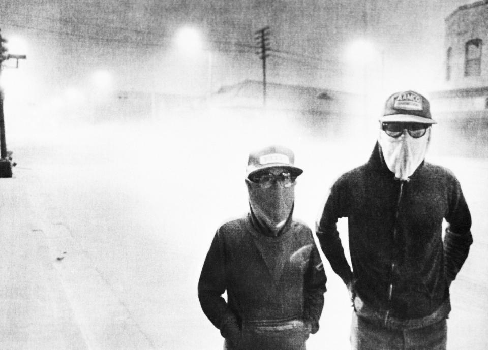 The streets of Yakima, Wash., are dark at 3 p.m. after an eruption at Mount St. Helens, May 18, 1980. White volcanic ash covers the streets and passersby wear masks to avoid breathing the ash.