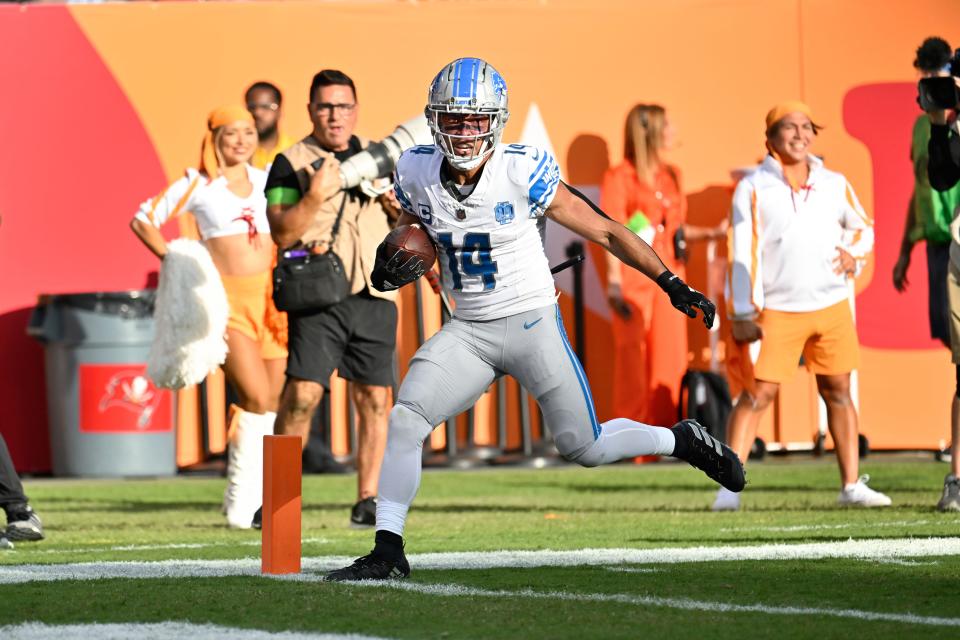 Detroit Lions wide receiver Amon-Ra St. Brown (14) scores on a 27-yard touchdown reception against the Tampa Bay Buccaneers during the first half at Raymond James Stadium in Tampa, Florida, on Sunday, Oct. 15, 2023.