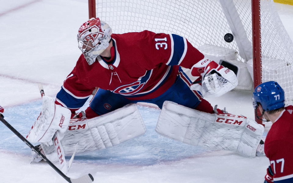 The puck goes into the net past Montreal Canadiens goaltender Carey Price for a goal by New York Rangers' Mika Zibanejad during the third period of an NHL hockey game Thursday, Feb. 27, 2020, in Montreal. (Paul Chiasson/The Canadian Press via AP)