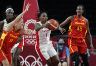 Canada's Shaina Pellington (1) grabs a rebound in front of Spain's Laia Palau (9) and Astou Ndour (45) during women's basketball preliminary round game at the 2020 Summer Olympics, Sunday, Aug. 1, 2021, in Saitama, Japan. (AP Photo/Charlie Neibergall)