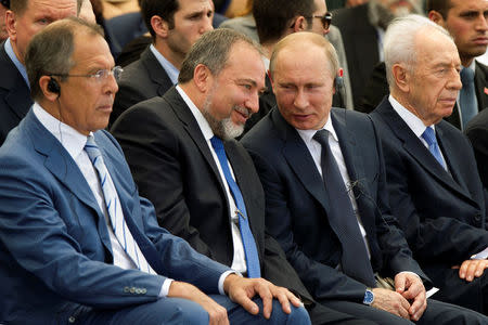 Israel's former Foreign Minister Avigdor Lieberman (2nd L) listens to Russia's President Vladimir Putin (3rd L) as Russia's Foreign Minister Sergei Lavrov (L) and Israel's former President Shimon Peres (R) sit beside them during an unveiling ceremony for a monument commemorating the victory of the Soviet Red Army in World War Two in Netanya, Israel June 25, 2012. REUTERS/Jack Guez/Pool/File Photo