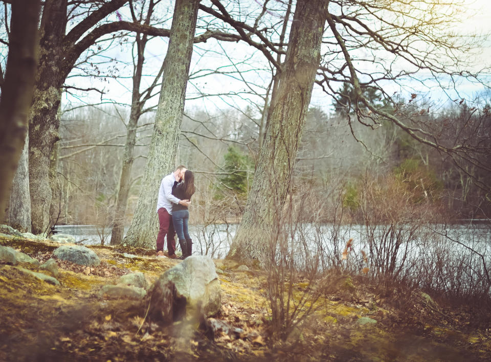 Heterosexual couple kisses passionately in illicit outdoor affair