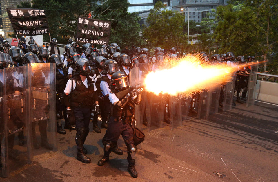 Police officers fire a tear gas during a demonstration against a proposed extradition bill in Hong Kong, China June 12, 2019. REUTERS/Athit Perawongmetha