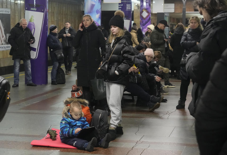 People rest in a subway station, being used as a bomb shelter during a rocket attack in Kyiv, Ukraine, Friday, Dec. 16, 2022. Ukrainian authorities reported explosions in at least three cities Friday, saying Russia has launched a major missile attack on energy facilities and infrastructure. Kyiv Mayor Vitali Klitschko reported explosions in at least four districts, urging residents to go to shelters. (AP Photo/Efrem Lukatsky)