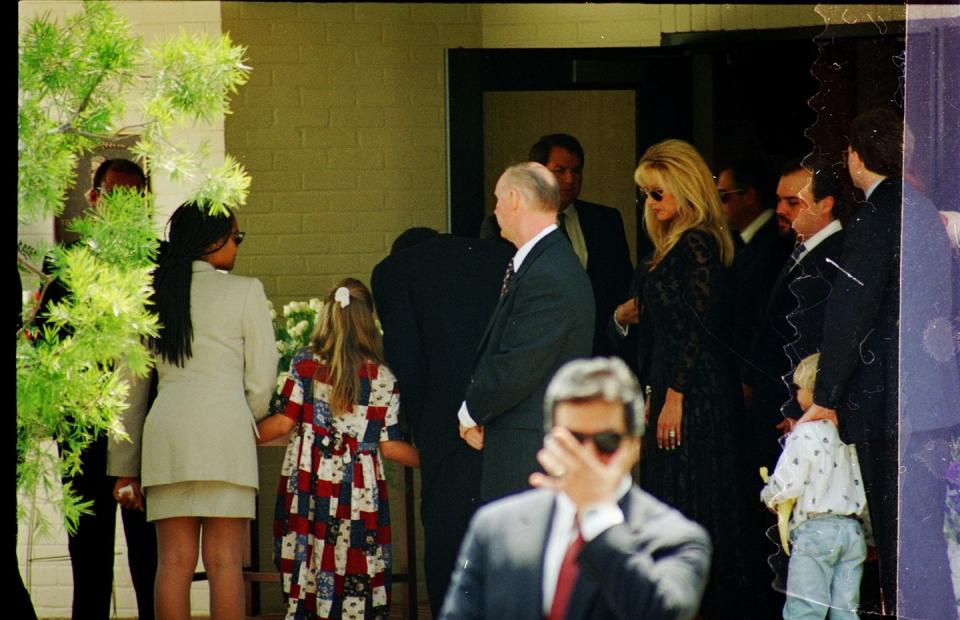 oj simpson and children walk outside a building as other people walk nearby