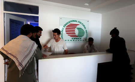 Pakistani men sign up for Chinese language classes at the China Pak Cultural Educational Institute in Islamabad, Pakistan June 9, 2017. REUTERS/Caren Firouz