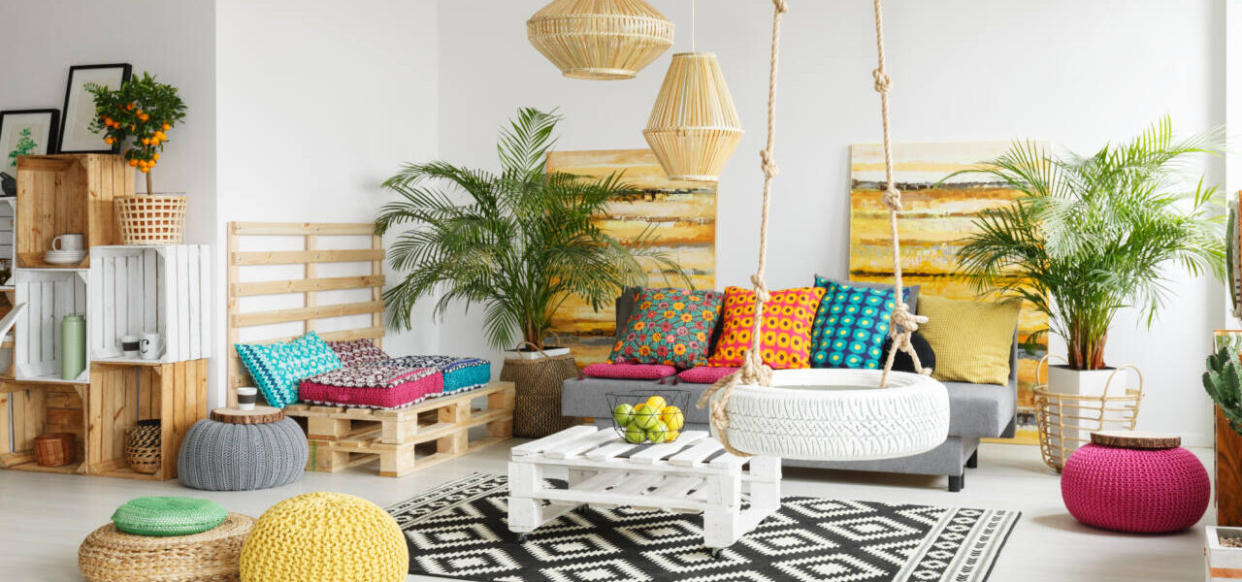 White, retro living room with pallet furniture and wheel swing