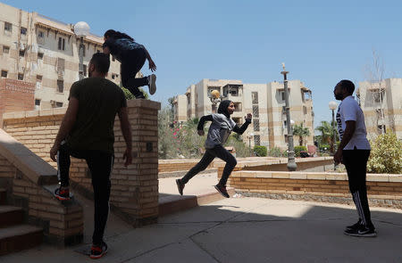 Mohamed Omran, coach at the all-female Parkour Egypt "PKE", watches his students' parkour skills around buildings on the outskirts of Cairo, Egypt July 20, 2018. REUTERS/Amr Abdallah Dalsh