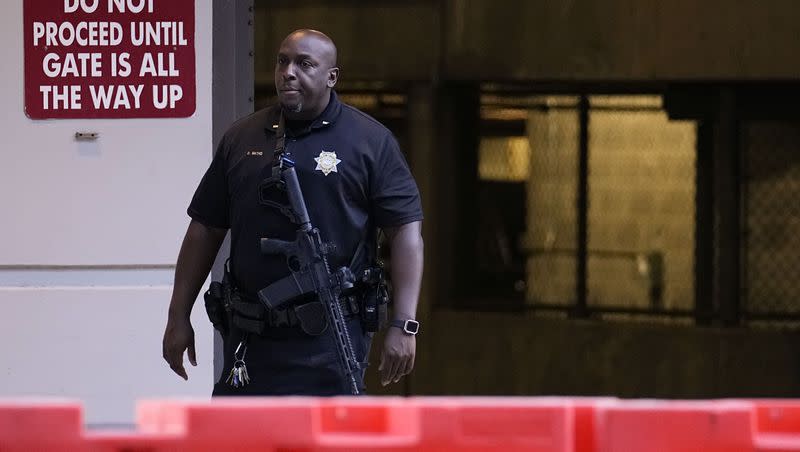 A police officer stands outside the Fulton County Courthouse, Monday, Aug. 14, 2023, in Atlanta. The indictment Fulton County District Attorney Fani Willis may bring as soon as this week could be the most sprawling case against former President Donald Trump.