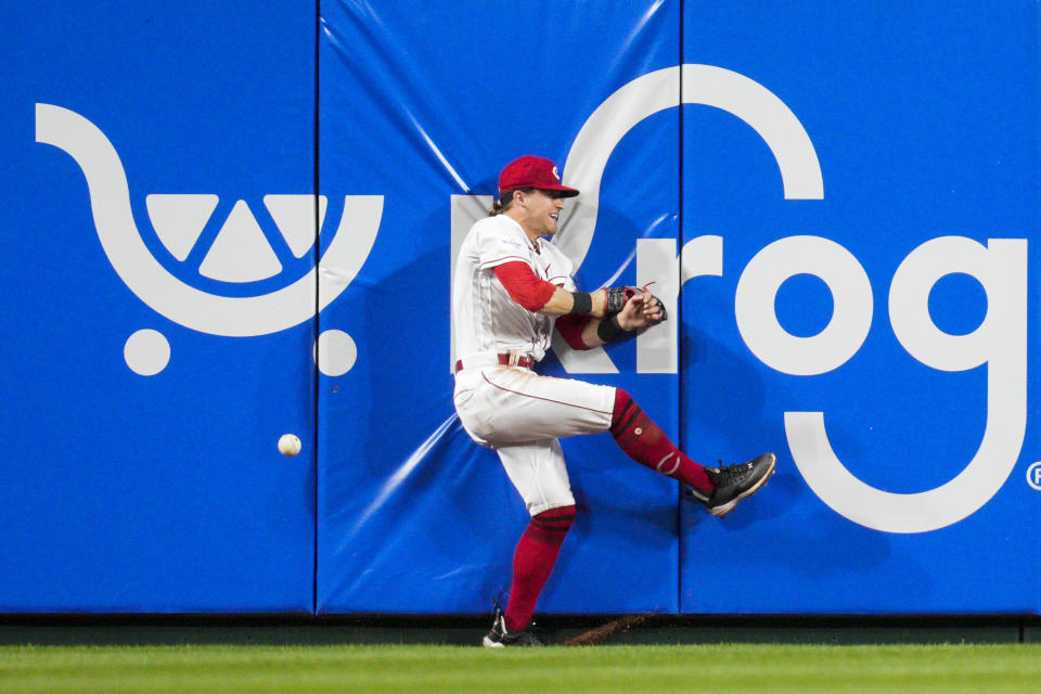 Cincinnati Reds center fielder TJ Friedl fails to catch a line drive by Chicago Cubs' Nico Hoerner in the seventh inning of a baseball game in Cincinnati, Tuesday, April 4, 2023. (AP Photo/Jeff Dean)