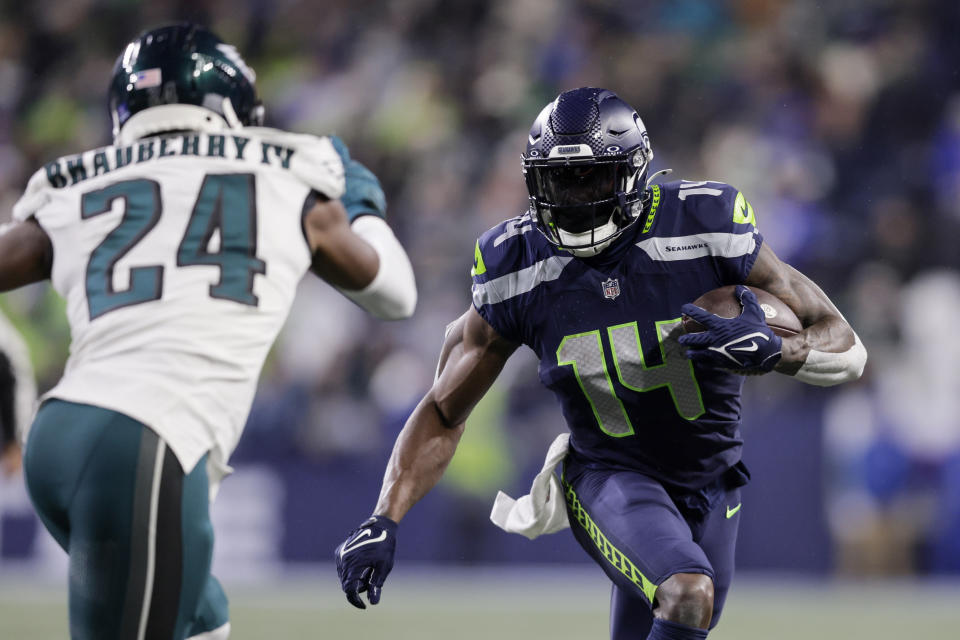 Seattle Seahawks wide receiver DK Metcalf runs with the ball against Philadelphia Eagles cornerback James Bradberry (24) during the second half of an NFL football game, Monday, Dec. 18, 2023, in Seattle. (AP Photo/John Froschauer)