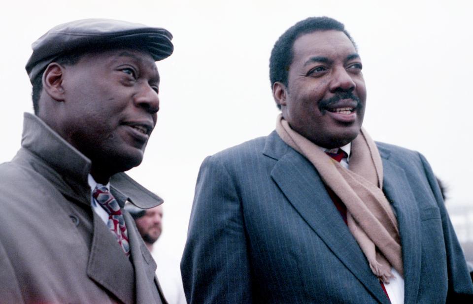 D'Army Bailey, left, chairman of The National Civil Rights Museum Foundation, and Hank Thomas, who was on the firebombed bus as a Freedom Rider in 1961, watch a replica of the bus burn at the Tennessee State Fairgrounds Feb. 7, 1991.