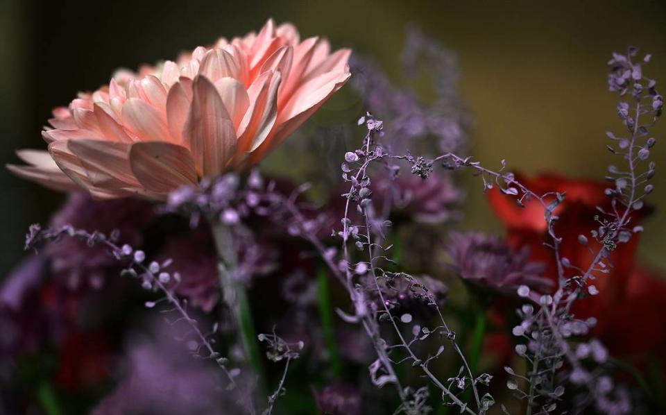 Sympathy flowers covered a table in the home of Matilda DuBois, the mother of shooting victim Sacouya Brice.