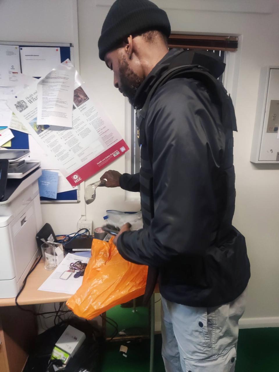 He inspects the blade before taking it to a police station for disposal (Barney Davis/The Independent)