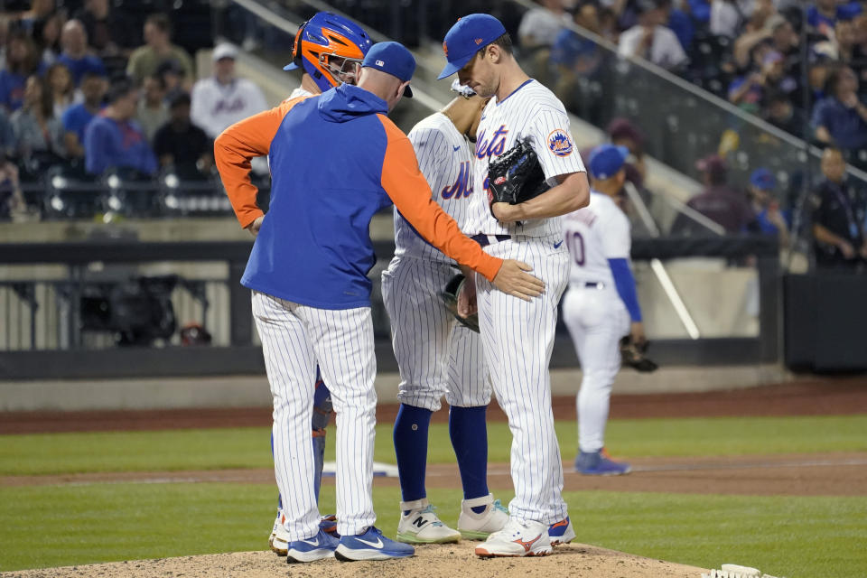 New York Mets pitching coach Jeremy Hefner, left, has a mound conference with pitcher Chris Bassitt during the sixth inning of a baseball game against the Pittsburgh Pirates, Saturday, Sept. 17, 2022, in New York. (AP Photo/Mary Altaffer)