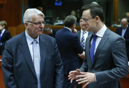 Polish Foreign Minister Witold Waszczykowski (L) talks with Hungarian Foreign Minister Peter Szijjarto at the start of an European Union foreign ministers meeting at the European Council in Brussels, Belgium, January 18, 2016. REUTERS/Yves Herman