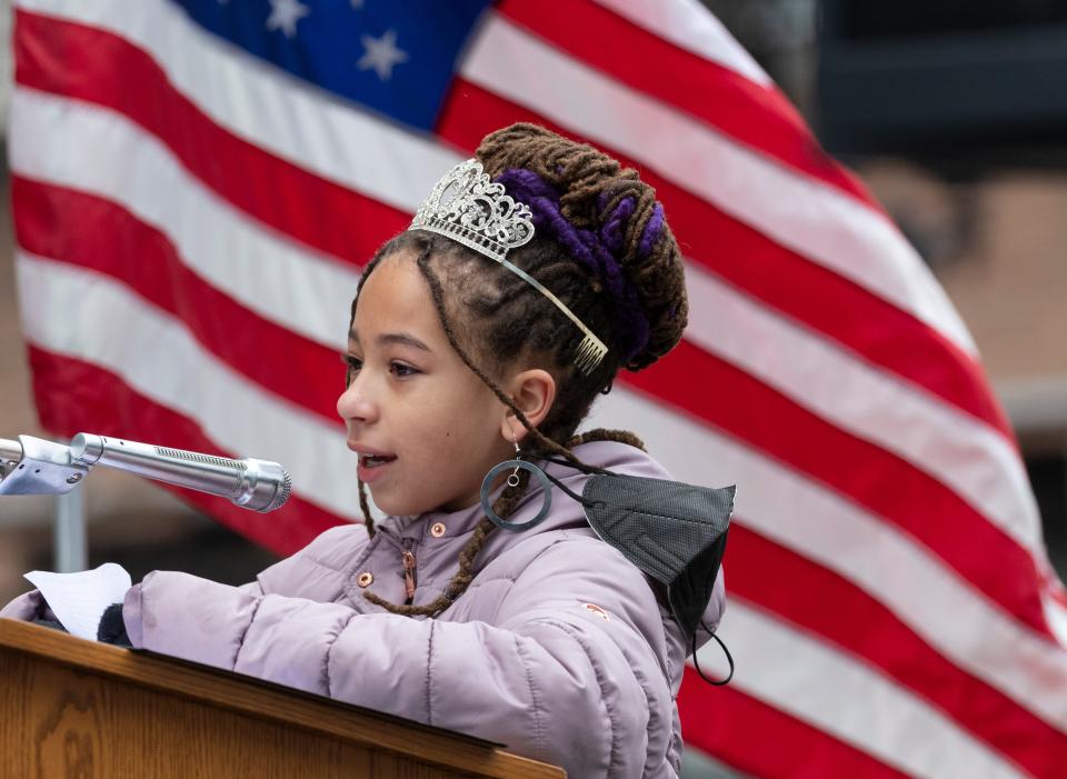Little Miss Juneteenth Kali May Free reads a poem during a ceremony where the last few blocks of what was 3rd Street in downtown Milwaukee have been renamed Dr. Martin Luther King Jr. Drive at its intersection with West Wisconsin Avenue Monday, Jan. 17, 2022, in Milwaukee.