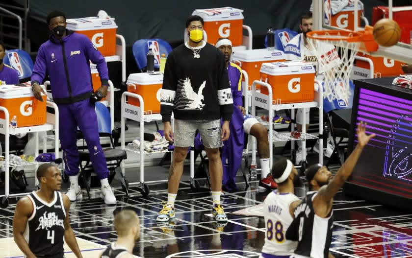 LOS ANGELES, CA - APRIL 04: Los Angeles Lakers forward Anthony Davis (3), injured, looks on from the sideline while the Lakers play the LA Clippers in the first quarter at the Staples Center on Sunday, April 4, 2021 in Los Angeles, CA. (Gary Coronado / Los Angeles Times)