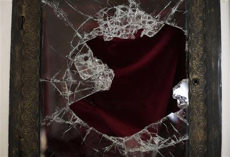 A broken glass of a niche where the reliquary with the blood of the late Pope John Paul II was located is seen in the small mountain church of San Pietro della Ienca, near the city of L'Aquila January 28, 2014 .Thieves broke into a small church in the mountains east of Rome over the weekend and stole the reliquary with the blood of the late Pope John Paul II, a custodian said on Monday. REUTERS/Max Rossi