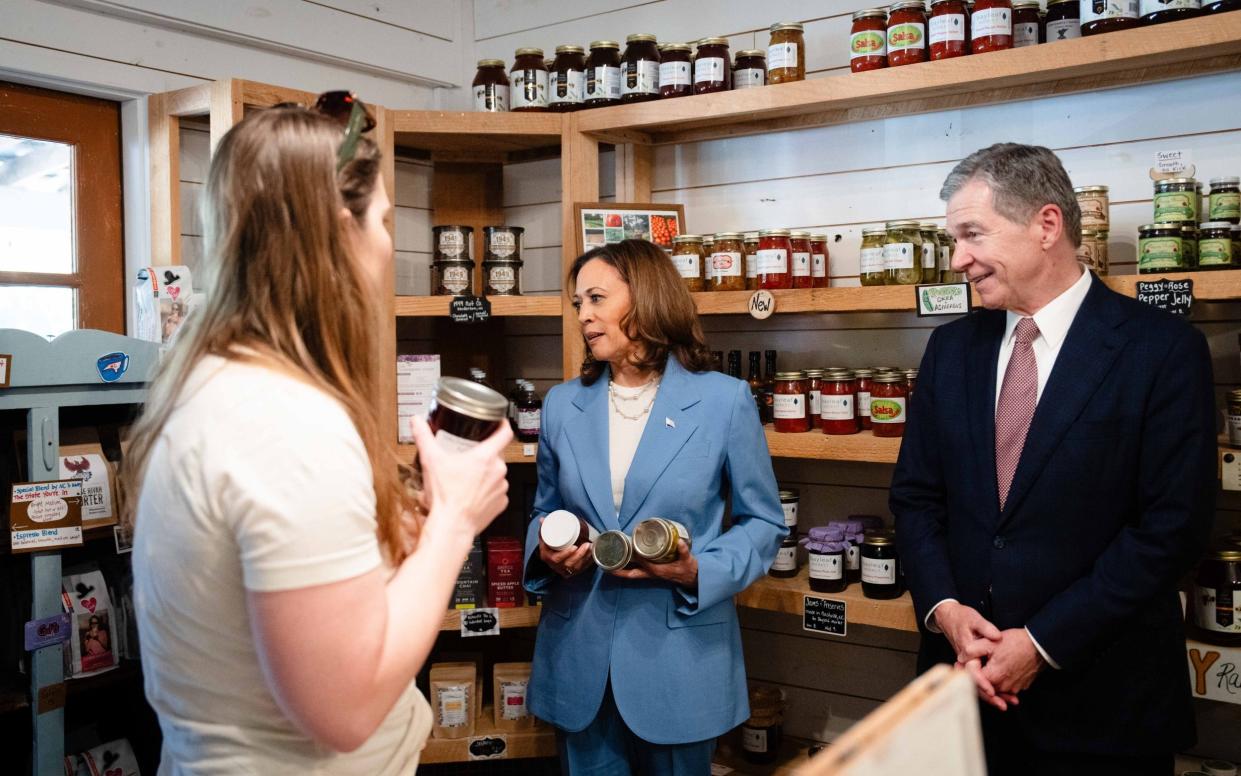 Kamala Harris, here with North Carolina Governor Roy Cooper, has said she would target 'bad actors' among grocery chains