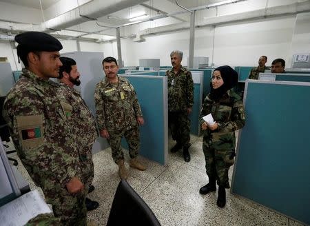 First Lieutenant for the Afghan National Army (ANA), Zainab Baqiri Shayan, 24, speaks with her colleagues in the radio operating department at the Ministry of Defence in Kabul, Afghanistan, October 31, 2016. REUTERS/Mohammad Ismail