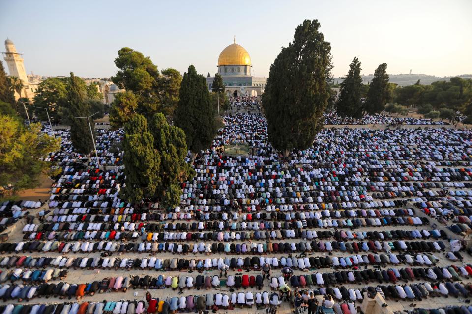 Tens of thousands of Muslim worshipers attend Eid al-Adha prayer next to the Dome of the Rock Mosque in the Al Aqsa Mosque compound in Jerusalem's old city, on Tuesday, July 20, 2021.