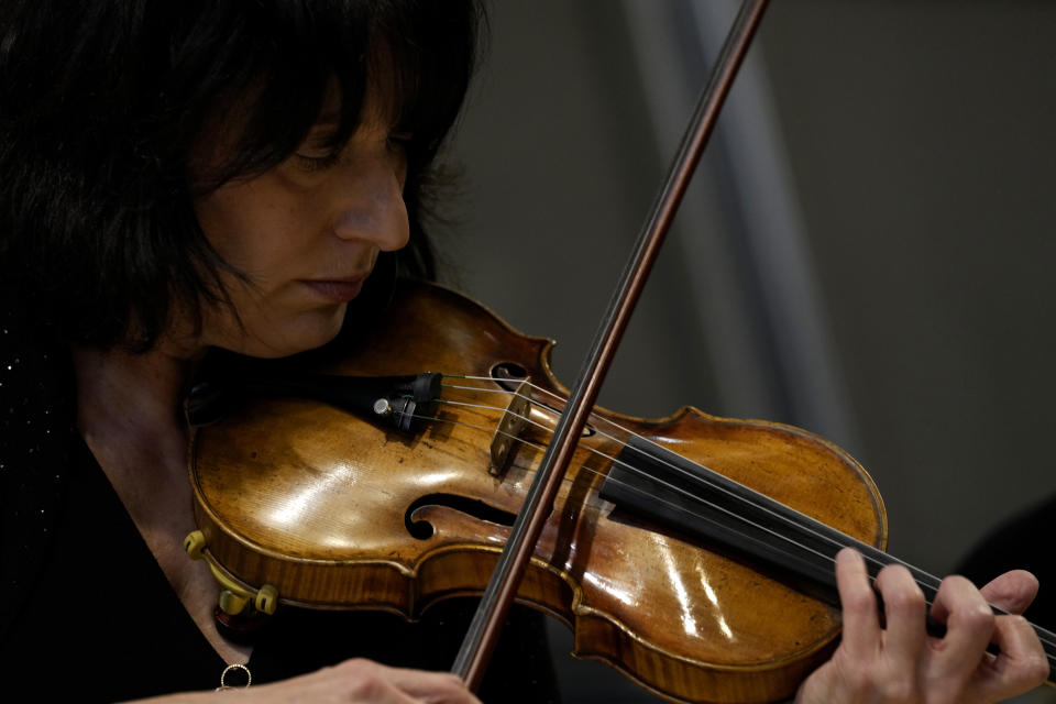 Principal Second Violin of the National Symphony Orchestra (NSO) Marissa Regni plays a violin, one of a rare Italian string instruments from the 17th and 18th century used for the concert, at the backstage of Milan's La Scala theatre, Italy, Monday, Feb. 26, 2024. (AP Photo/Antonio Calanni)
