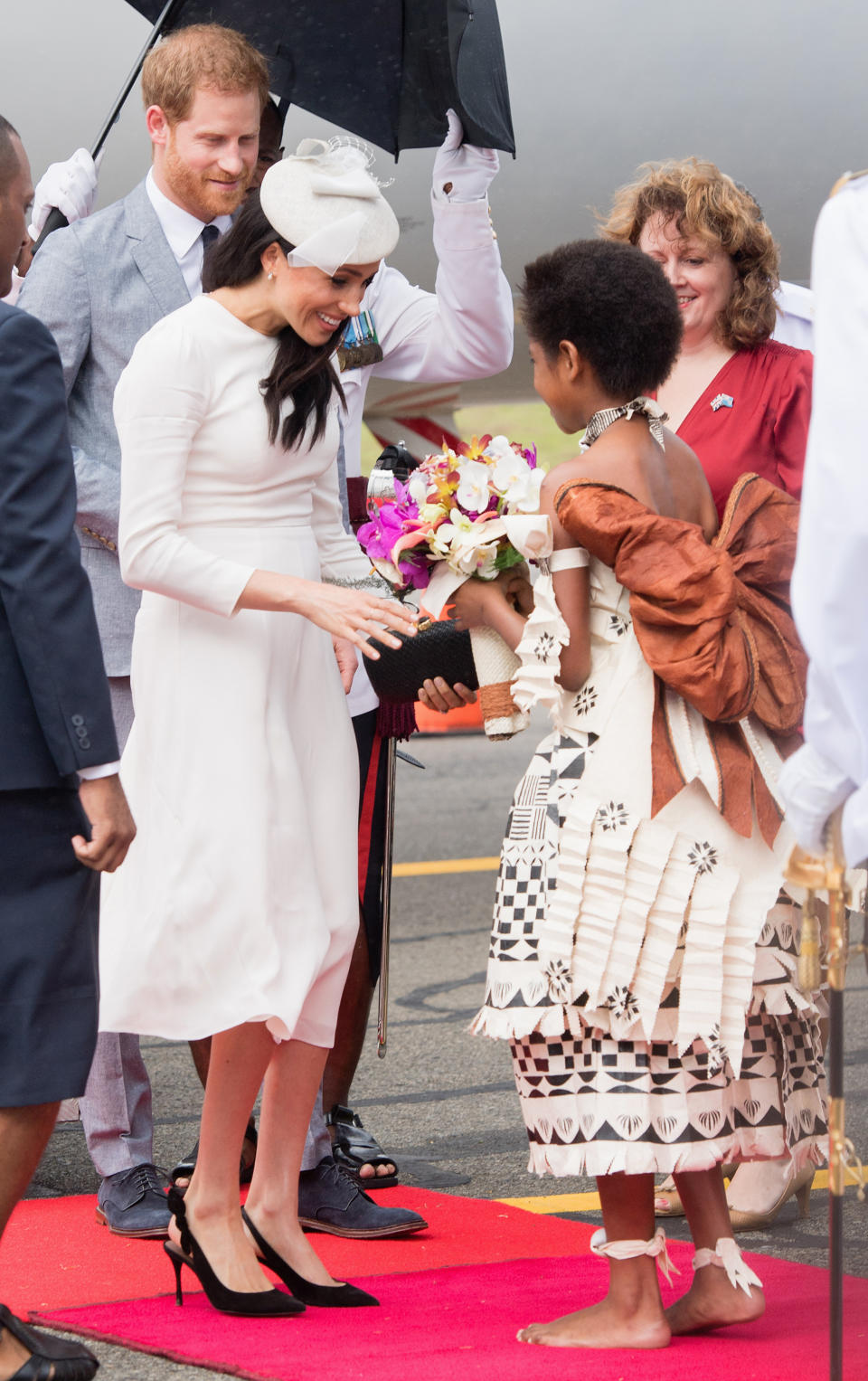 Meghan is given a warm welcome with some flowers. Photo: Getty