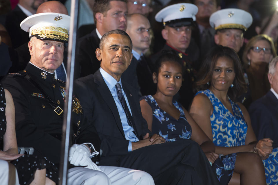 Marine Commandant Gen. James Amos, President Barack Obama, Sasha Obama and first lady Michelle Obama look on during the Marine Barracks Evening Parade, on Friday, June 27, 2014, in Washington.