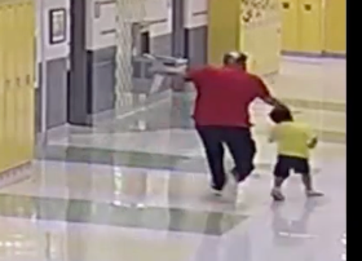 Footage shows the pre-school employee strike the boy from behind, causing him to fall heavily to the hallway floor (Taneshia Lindsay / Facebook)