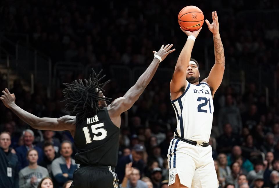 Mar 6, 2024; Indianapolis, Indiana, USA; Butler Bulldogs guard Pierre Brooks (21) makes a three-point basket over Xavier Musketeers center Kachi Nzeh (15) during the first half at Hinkle Fieldhouse.