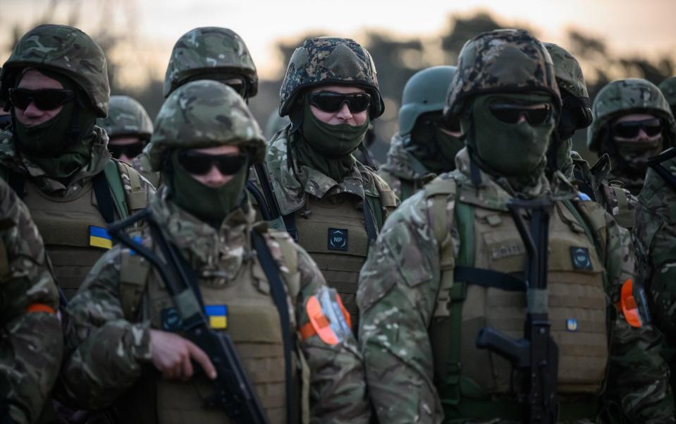 Ukrainian volunteer recruits prepare to take part in prayers, blessings and a one-minute silence to mark the first anniversary of the 2022 Russian invasion of Ukraine - Leon Neal/Getty