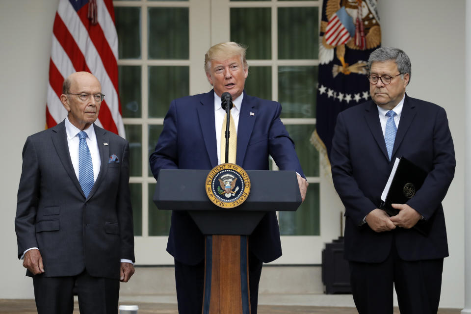 President Donald Trump is joined by Commerce Secretary Wilbur Ross and Attorney General William Barr, right, as he speaks in the Rose Garden at the White House in Washington, Thursday, July 11, 2019. (AP Photo/Carolyn Kaster)