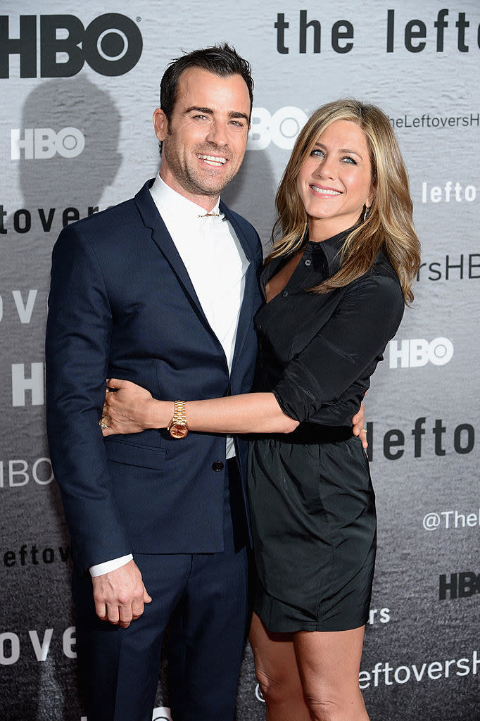 Justin Theroux (L) and Jennifer Aniston with their arms around each other at "The Leftovers" premiere