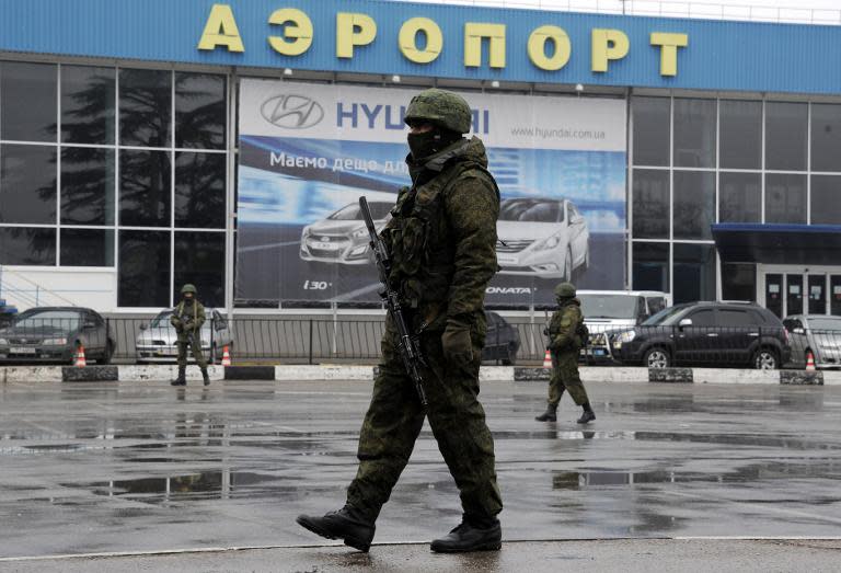 File picture shows unidentified armed men on patrol outside Simferopol airport, in the Crimea on February 28, 2014