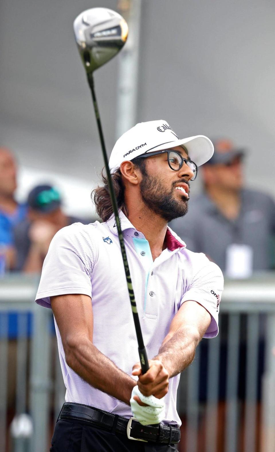 Akshay Bhatia watches the flight of his tee shot from the first tee box during second round action in the Wells Fargo Championship at Quail Hollow Club in Charlotte, NC on Friday, May 5, 2023.