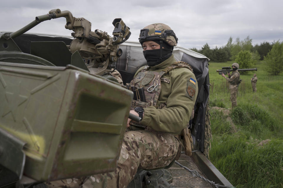 Members of a Ukrainian air-defense unit demonstrate their work near Kyiv on Monday, May 8, 2023. From camouflaged positions, the units dart out by truck into the farm fields around the capital, ready to take down enemy drones or missiles. Since Russia resumed regular air attacks on April 28, the units have a perfect score, intercepting every drone and missile shot at the capital. (AP Photo/Andrew Kravchenko)