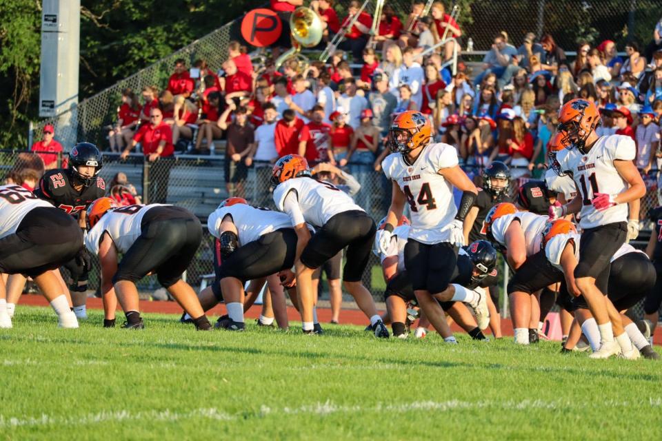 North Union's Owen Hoffer goes in motion before Carter Skaggs takes the snap during a season-opening football game at Pleasant last week.