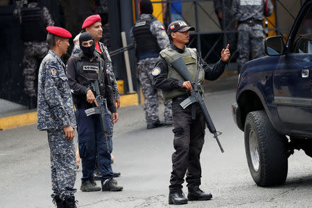 Members of the Bolivarian National Intelligence Service (SEBIN) stand guard outside a detention center of the Bolivarian National Intelligence Service (SEBIN), where a riot occurred, according to relatives, in Caracas, Venezuela May 16, 2018. REUTERS/Carlos Garcia Rawlins