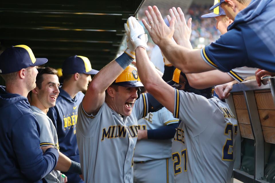 CHICAGO, ILLINOIS - AUGUST 28: Mark Canha #21 of the Milwaukee Brewers celebrates with Willy Adames #27 after hitting a two-run home run off Jameson Taillon #50 of the Chicago Cubs (not pictured) during the first inning at Wrigley Field on August 28, 2023 in Chicago, Illinois. (Photo by Michael Reaves/Getty Images)