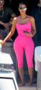 <p>In a neon pink Chanel jumpsuit and futuristic sunglasses while on a boat in Miami. </p>