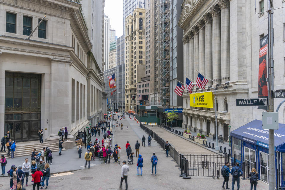 Wall Street and the front of the New York Stock Exchange.