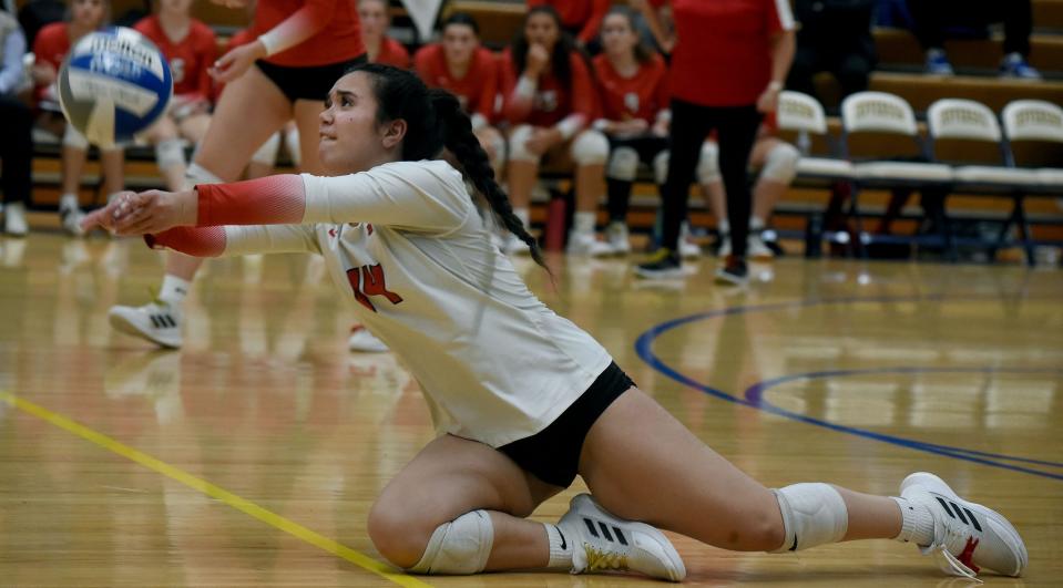 Amanda Gregorio of Milan dives for a dig in the Division 2 District semifinals against Airport Thursday.