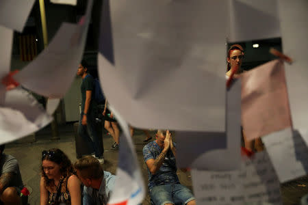 People gather at an impromptu memorial where a van crashed into pedestrians at Las Ramblas, in Barcelona, Spain, August 20, 2017. REUTERS/Susana Vera