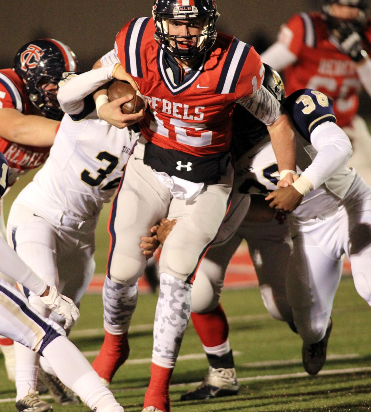 Teurlings Catholic quarterback Cole Kelley (12) runs for a first down in the second quarter against Holy Cross in high school football playoff game Friday, November 14, 2014, at Rebel Stadium in Lafayette, La.