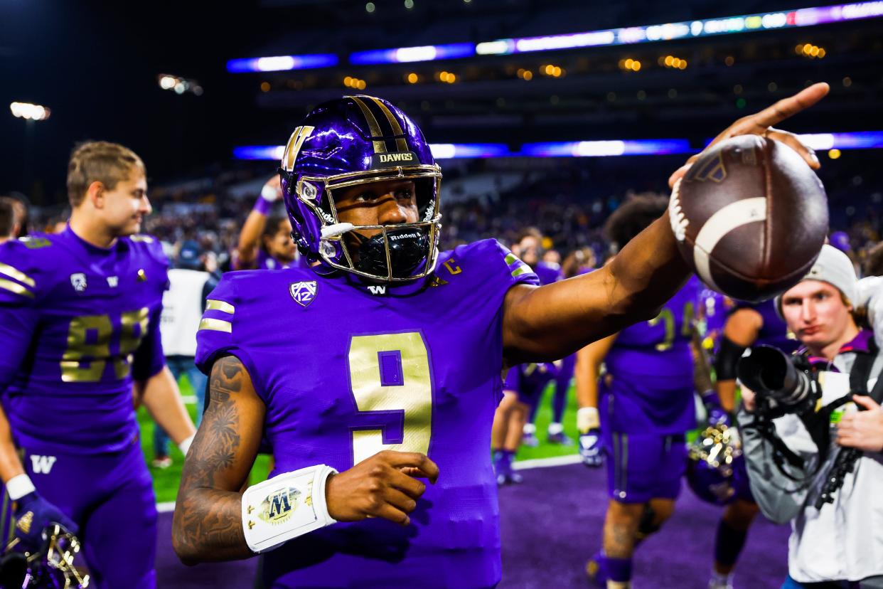 Washington Huskies quarterback Michael Penix Jr. (9) points to the crowd following a 15-7 victory against the Arizona State Sun Devils at Alaska Airlines Field at Husky Stadium.