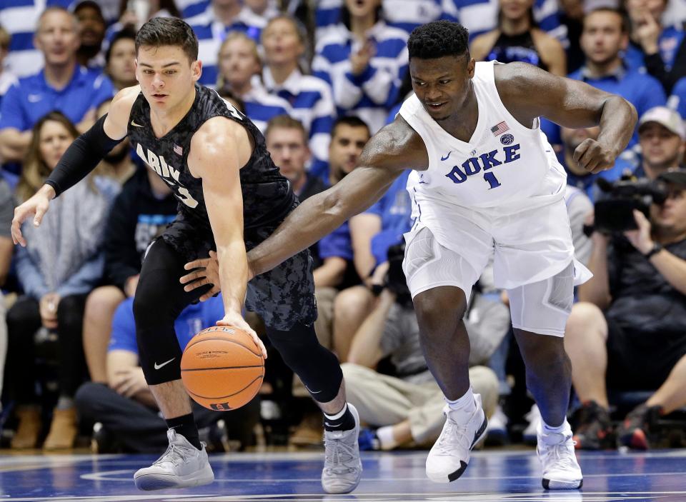 Army's Tommy Funk, left, and Duke's Zion Williamson (1) chase the ball during the first half of the two school's last meeting on Nov. 11, 2018. GERRY BROOME/AP