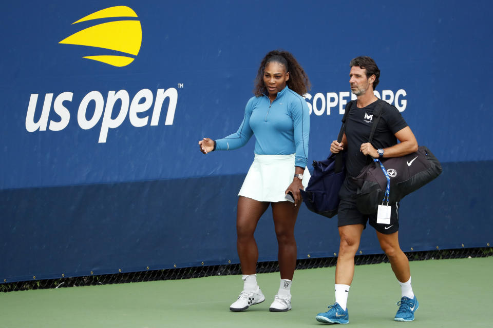 FILE - In this Aug. 31, 2018, file photo, Serena Williams walks on a practice court with her coach Patrick Mouratoglou during the third round of the U.S. Open tennis tournament in New York. The tenor of the final between Williams and champion Naomi Osaka, whose terrific performance was largely ignored amid the chaos that enveloped Arthur Ashe Stadium, began to shift after chair umpire Carlos Ramos warned Williams for receiving coaching signals. (AP Photo/Adam Hunger, File)