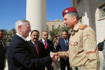 Iraqi Chief of Staff General Othman al-Ghanimi (R) welcomes U.S. Defense Secretary Jim Mattis at Ministry of Defence in Baghdad, Iraq February 20, 2017. REUTERS/Stringer