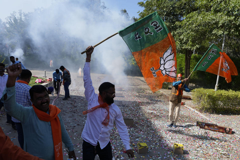 Bharatiya Janata party (BJP) supporters celebrate lead for the party in Gujarat state elections in Gandhinagar, India, Thursday, Dec. 8, 2022. Indian Prime Minister Narendra Modi’s Hindu nationalist party is all set to keep its 27-year-old control of his home Gujarat state in a record state legislature win. (AP Photo/Ajit Solanki)